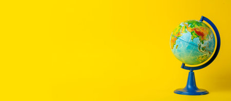 Earth globe on clean yellow banner background. Education, school, study and knowledge background...