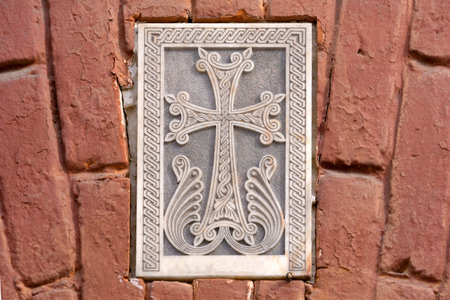 Armenian Christian cross carved in stone. Ancient ornamental christian cross on stone in churchの写真素材