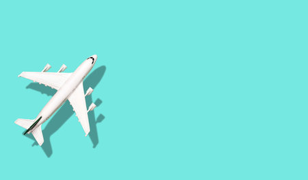Airplane on a colored blank banner background. Vacation, flying and tourism background minimal...