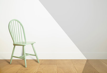 Empty room interior with white wall background and wooden floor. Chair in a light empty room with...