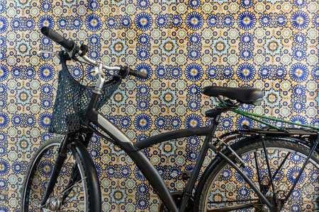 Old rustic vintage bicycle on the street near the color wall. Travel concept. Bike ride. Postcard. Copy space.の写真素材