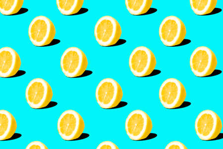 Fresh lemon (lemons) pattern on blue background. Minimal concept. Summer minimal concept. Flat layの写真素材
