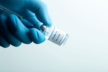 Vaccine against COVID-19. Glass medical vials with liquid. Ampoules with coronavirus vaccine on a...