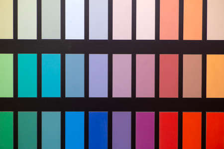 Paint color swatches in the background interior design studio. Selection Various colors and shades of paint for interior design and decoration worksの写真素材