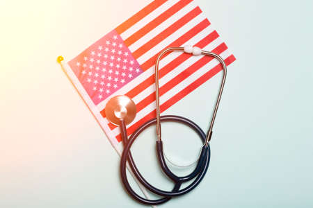 USA medicine background. Stethoscope on the American flag. Healthcare and medical services in the USA concept.の写真素材