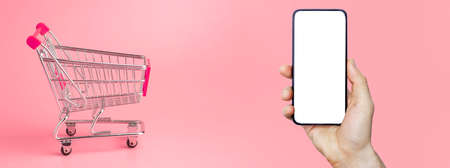 Online grocery delivery app in a mobile phone. Food market service in smartphone. Grocery delivery background concept. Shopping cart.の写真素材