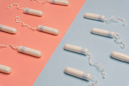 Menstruation concept with tampons and pads on bright blue background. Woman menstruation cycle concept.の写真素材