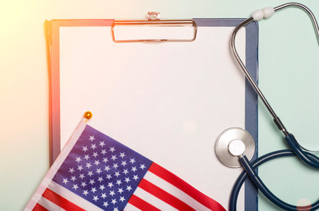 USA medicine background. Stethoscope on the American flag. Healthcare and medical services in the USA concept.の写真素材