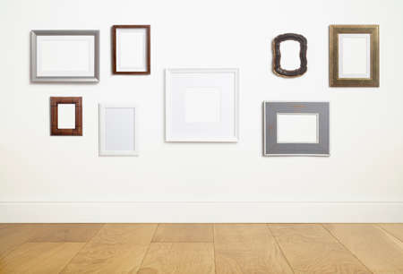 Mock up empty white frame background. Different decorative empty frames for a photo or painting in a light Scandinavian minimalist interior on a white clean wall.の写真素材
