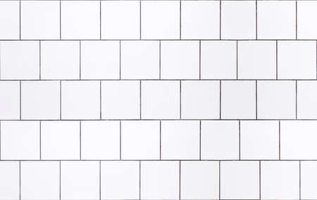 White tile background. Wall with white tiles for the interior of the kitchen or bathroom in the house. Decor, design and decoration of kitchen and bathroom interiorsの写真素材