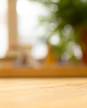 Wooden table background near the blurred window in the living roomの写真素材
