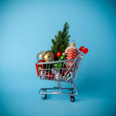 Christmas tree with decorations in a supermarket cart. Christmas shopping and sale conceptの写真素材
