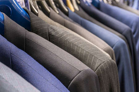 Mens jackets suits in blue and gray in a mens clothing store. Mens business suitの写真素材