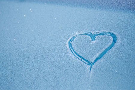 Heart painted on a frozen car glass. copyspace.の写真素材