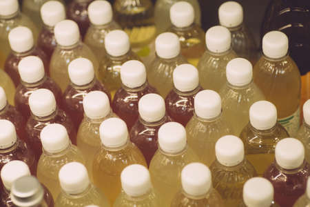 Natural fruit drinks in disposable plastic bottles. Plastic bottles on a shop window.の写真素材