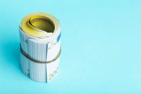 Money and income concept. Euro cash banknotes on a blue background. Saving and spending moneyの写真素材
