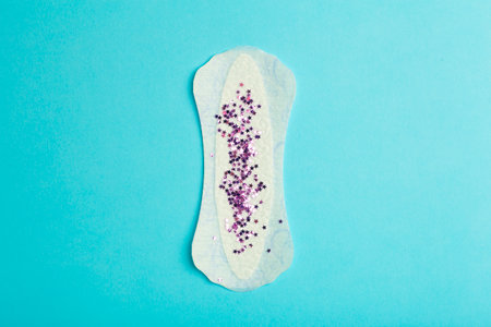 Menstruation concept. Woman menstruation cycle women's period and critical days. Sanitary pad on blue background. High quality photoの写真素材