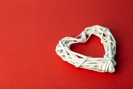 Love Valentine's day background or wedding background. White heart on a red pastel background. Love...