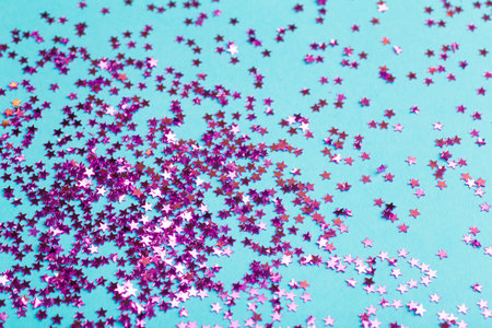 Glitter on a blue background. Celebration, party, birthday magic background. Creative minimal art...