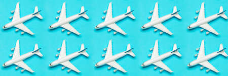 Travel minimal background banner. Model airplane in flight on an empty colored background. Copy spaceの写真素材