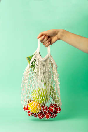 Zero waste concept. String bag in a female hand with products from the supermarket. Plastic bags free.の写真素材
