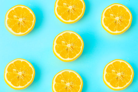Summer and vitamins background. Lemon on a blue background, minimal food concept