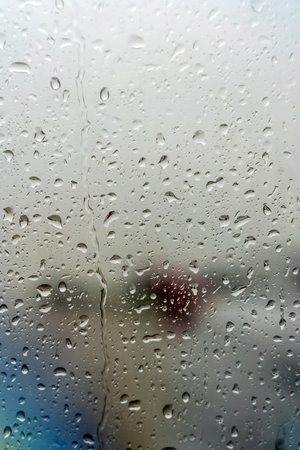 Raindrops on the window. Drops of condensation water and wet on the glass background. Rainy cloudy...