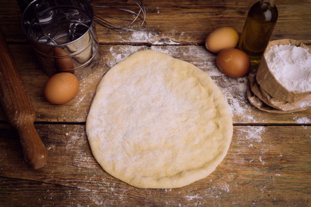 Pizza dough cooking in the home kitchen. Homemade dough for bread, pizza, pastries and rolls. Dough...