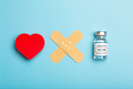 Vaccination concept. Ampoule of virus vaccine on blue medical minimal background.