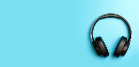 Wireless sound Audio headphones on a colored banner background. Music app, listening to podcasts, radio and audiobooks concept. high quality photoの写真素材