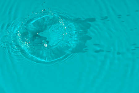 Water tranquil ripple background. Water texture, circles and bubbles on a liquid blue surface. Cosmetic products and flat design concept. high quality photoの写真素材