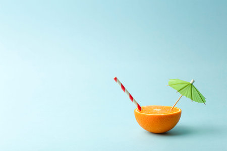 Food summer minimal concept. Orange juice and juicy tropical fruits on a light colored background