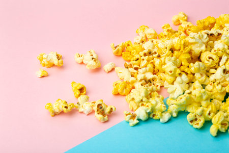 Popcorn on a colored background. Minimal food concept. Entertainment, film and video content. Aesthetics 80s and 90s conceptの写真素材
