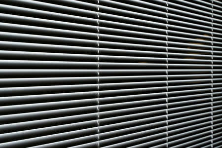 Blinds background. Window with metal shutters in the interior of the living roomの写真素材