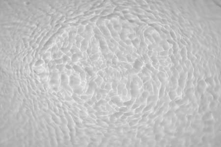 Water tranquil ripple background. Water texture, circles and bubbles on a liquid white surface. Cosmetic products and flat design conceptの写真素材