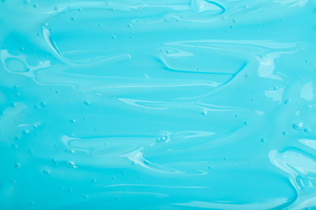 Cosmetic gel background. Blue transparent gel with texture and bubbles close upの写真素材