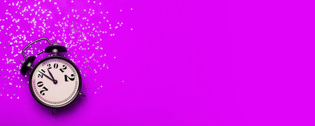 New Year 2022 banner background concept. 2021 changes to 2022 on an alarm clock on a pink background...
