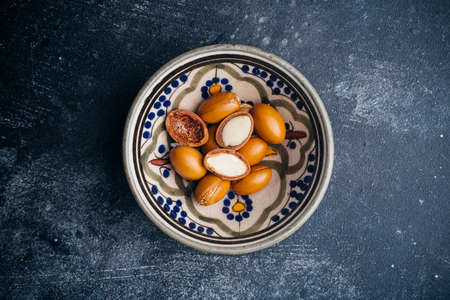 Argan seeds on a dark background. Argan oil based cosmetics concept.の写真素材