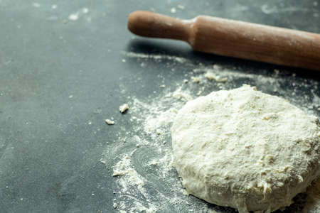Dough pizza background. Cooking pizza dough or bread on the kitchen table. Food backgroundの写真素材