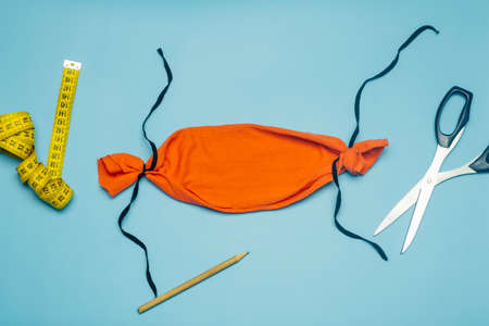 Face mask DIY tutorial and making homemade mask concept. Without sewing an individual antibacterial protective mask pattern from colored fabric at homeの写真素材