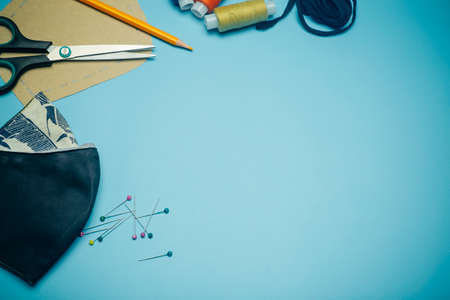 Face mask sewing DIY and making homemade  mask concept. Sewing an individual antibacterial face mask from colored fabric at homeの写真素材