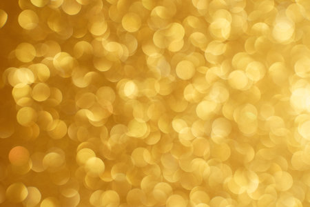 Golden bokeh background. Texture foil and confetti bokeh, light of golden dust. Festive party...