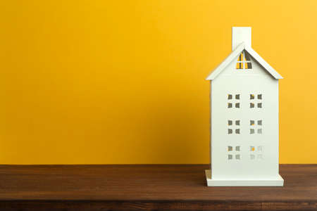Toy house on yellow background. Real estate, rental housing and house concept.の写真素材