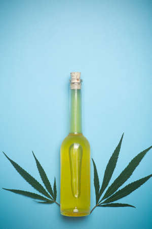 Cannabis oil cannabidiol. Medical cannabis marijuana and extract cbd on blue background.の写真素材