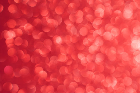 Red bokeh background. Texture foil and blurred confetti, light of golden dust. Festive party...