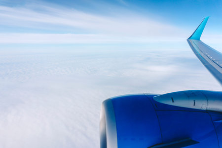 Airplane flight background. View from the airplane window to the sky and clouds.