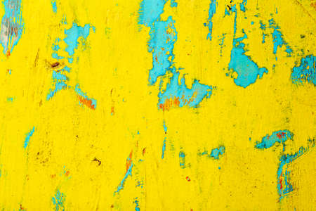 Old painted wood. Old peeling yellow paint with texture on wooden backgroundの写真素材