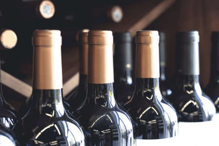 Wine bottles with blank labels on the counter of a liquor store. Wine background. Selected focusの写真素材