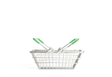 Shopping cart in a supermarket on an empty white background isolate. Shopping, groceries, goods concept.の写真素材