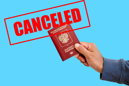 Russian foreign passport in the hands of a man. Prohibition of Schengen visas for Russian tourists...
